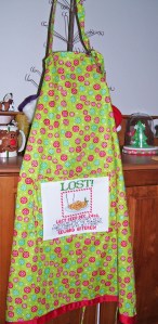 lost cookies apron, cross stitch design, red, green, snowflake fabric
